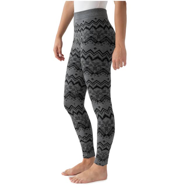 Model in patterned black and gray high waist leggings 