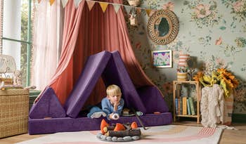 a boy playing in a purple corded nugget couch