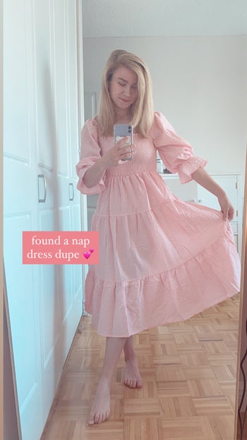 A BuzzFeed editor in a pink and white gingham maxi dress with puff sleeves