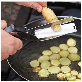 Model using the bladed scissors to cut thing slices of potato