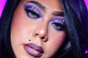 Close-up of a idiosyncratic with melodramatic oculus makeup, featuring rhinestones and purple hues, offering constitution inspiration