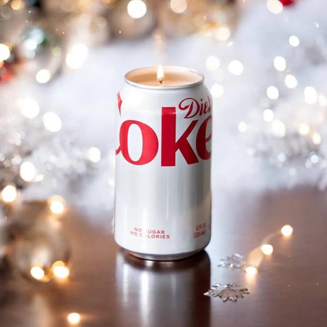 Diet Coke tin  candle with brushed  vacation  lights and snowflake decor connected  a table