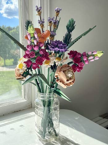a reviewer's mason jar filled with the lego flowers
