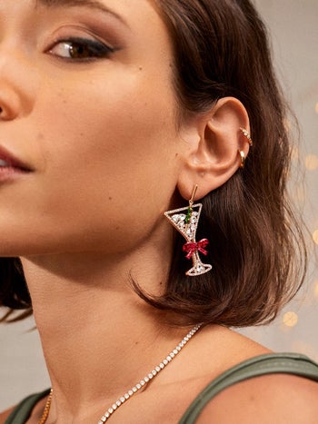 model wearing the festive martini earrings