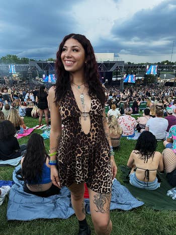 Person outdoors astatine a euphony festival wearing a leopard people formal with layered necklace