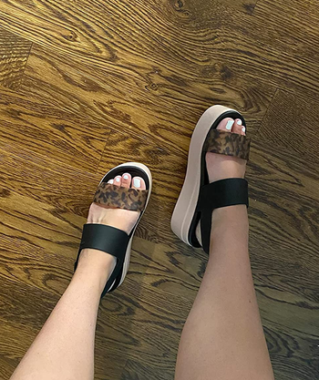 reviewer wearing the leopard print sandals