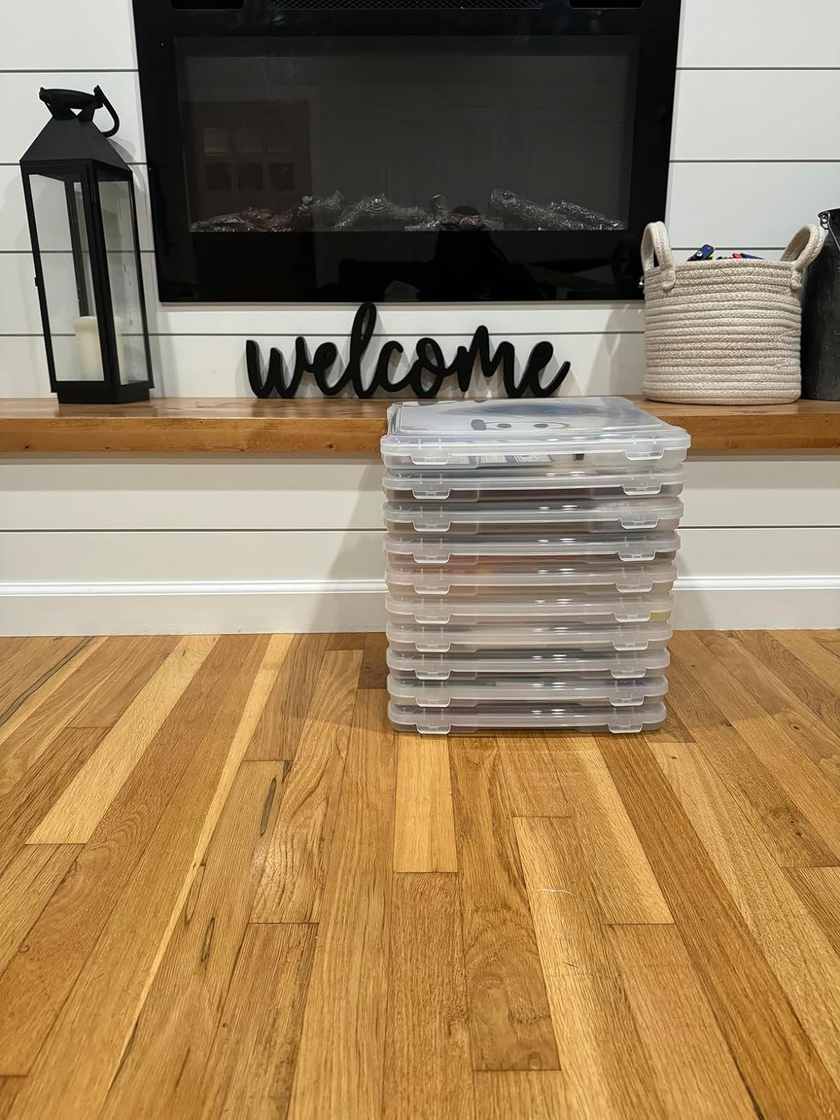 Stack of storage containers in front of a fireplace with a 