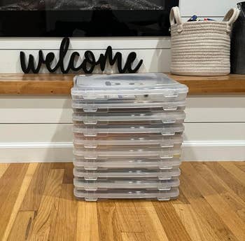 Stack of storage containers in front of a fireplace with a