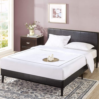 a black faux leather bed frame