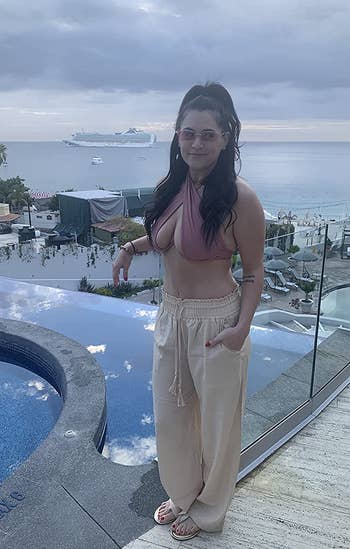 reviewer photo wearing beige linen pants, overlooking pool at Cabo