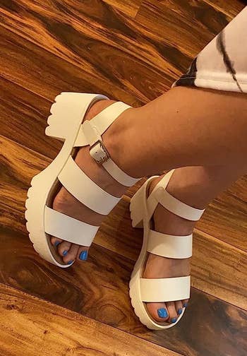 a reviewer wering the sandals in white 