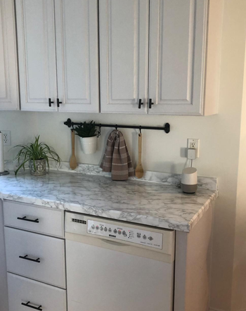 after of the countertop covered in faux marble contact paper