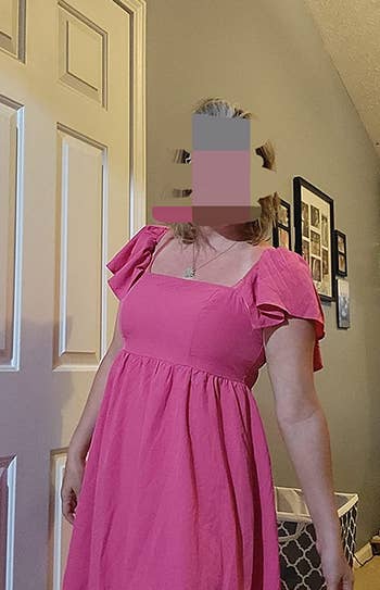 Reviewer wearing hot pink baby doll dress with ruffle short sleeves