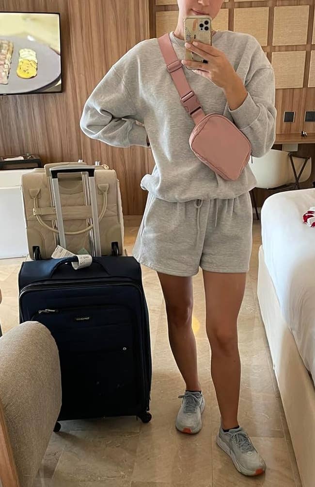 reviewer wearing pink fanny pack as crossbody bag