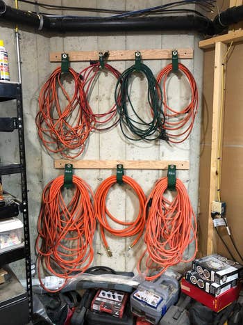 Organized garage wall with neatly hung extension cords and tools, showcasing efficient storage solutions