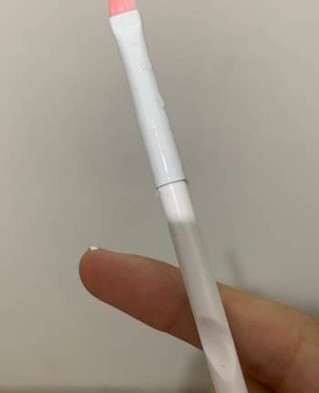 reviewer holding liner brush 