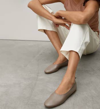 model wearing the taupe flats