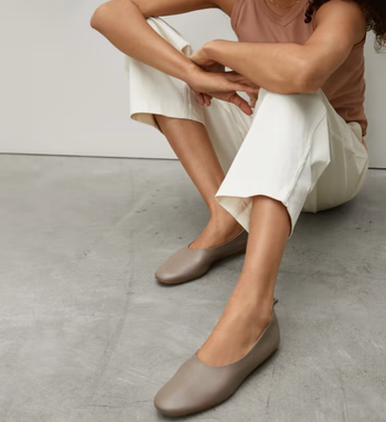 model wearing the taupe flats