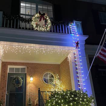 The ladder with multicolored lights hanging off the side of a reviewer's house