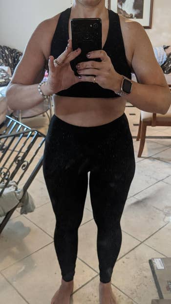 reviewer wearing the black leggings with a black sports bra