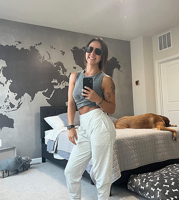 reviewer wearing the white joggers with a gray crop top
