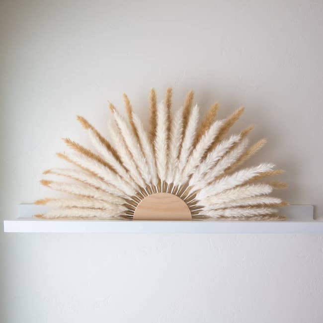 arched sun made of half circle piece of wood and pampas grass beams
