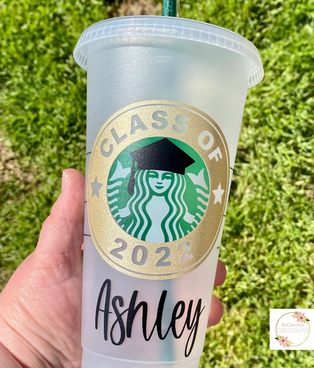 person holding class off 2022 customizable starbucks cup that reads ashley on it