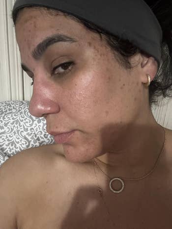 Person with a headband, earrings, and a necklace, showing a close-up of their look   with a earthy  expression