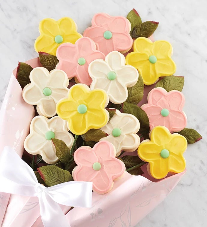 A bouquet of 12 long stemmed flower cookies in pink, yellow, and cream