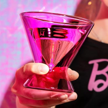 A model holding the hot pink glass 