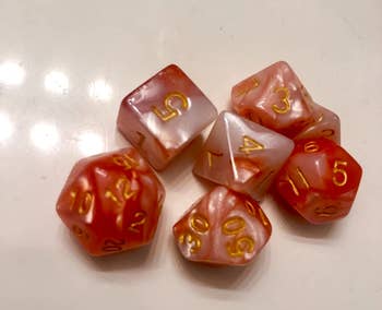 a reviewer photo of a set of dice that were inside the bath bomb 