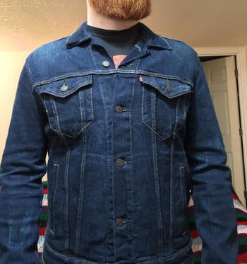 reviewer wearing the denim jacket buttoned up 