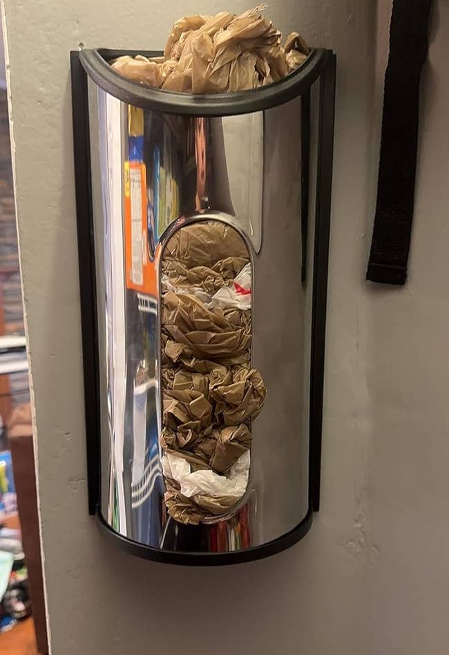 reviewer photo of the dispenser inside of pantry holding bags