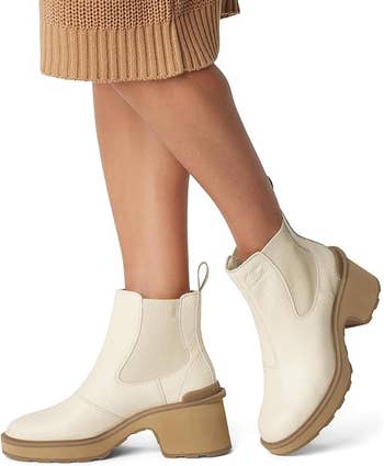 a model wearing the beige boots