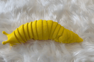 a gif of the yellow slug fidget toy
