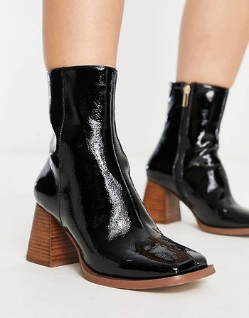  model in the black mid heel boots