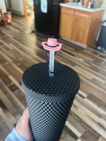 pink cowboy hat straw topper on black tumbler