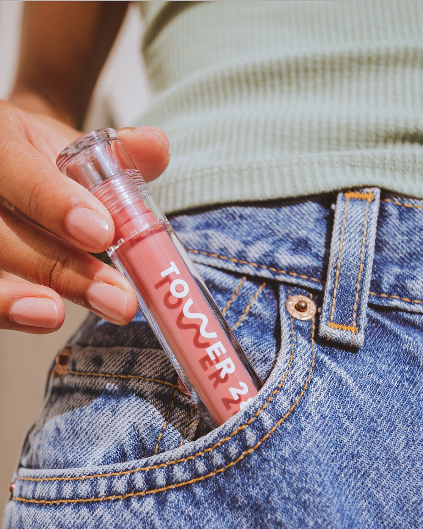 someone taking the pistachio lip jelly out of their jean pocket