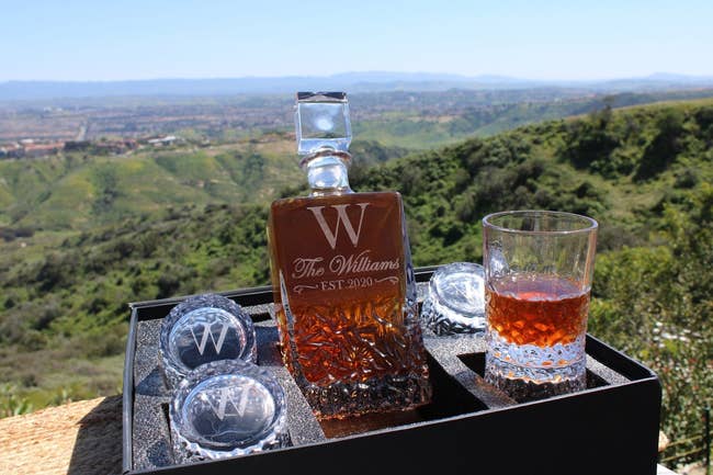 a whiskey decanter and glasses that have a W engraved on them