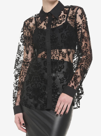 a model wearing a black lace long sleeve collared top with a design of the haunted mansion wall paper in the lace