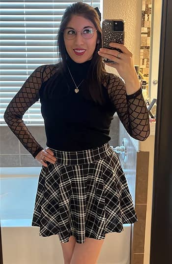 a reviewer wearing the skirt in black and white plaid 