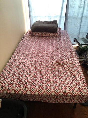 reviewer photo of bedding on top of twin bed frame