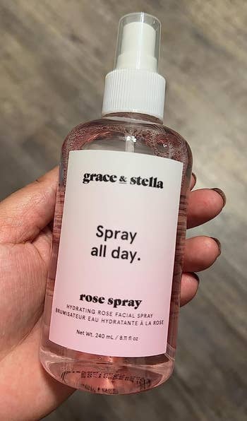 reviewer holding the rose spray