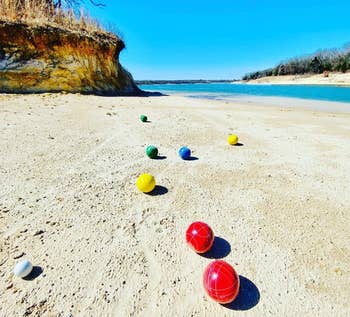 reviewer photo of the bocce balls on a sandy beach