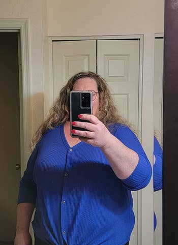 a reviewer wearing the top in blue 