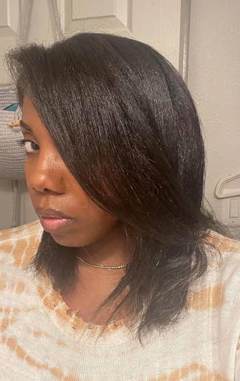 black reviewer with shiny, straightened shoulder-length hair
