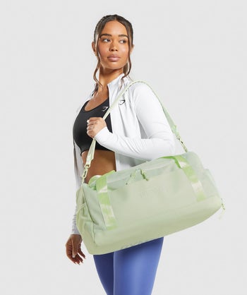 model holding light green gym bag