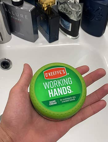 reviewer holding jar of working hands hand cream
