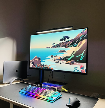 reviewer's Screenbar on a monitor lighting up their workspace