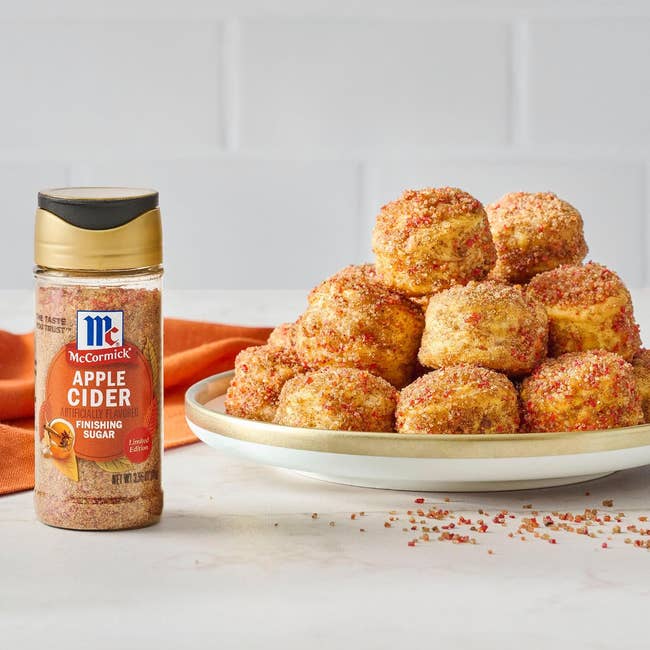 a sheet  of doughnut balls adjacent  to the finishing sugar
